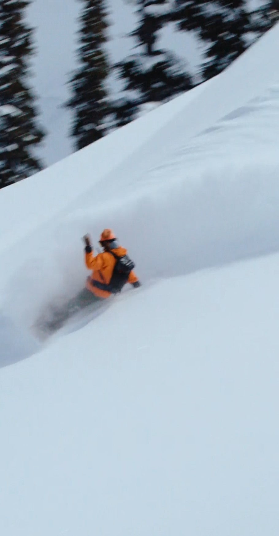 Snowboarder turning in deep powder