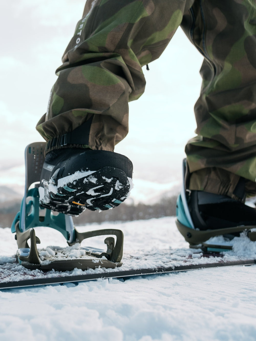 Snowboarder stepping into a Burton Step On binding