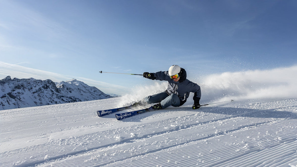 Skier carving on a groomed slope